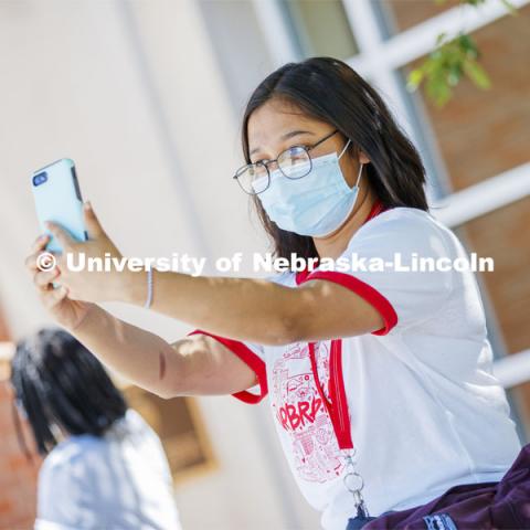 Sandhya Karki takes a selfie of herself wearing a mask. Photo shoot of students wearing masks and practicing social distancing. June 24, 2020. Photo by Craig Chandler / University Communication.