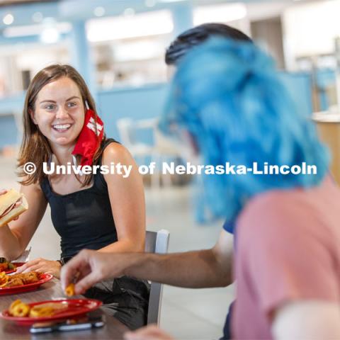 Students eating in the Willa Cather Dining Center. Photo shoot of students wearing masks and practicing social distancing in dining services in Willa Cather Dining Center. July 1, 2020. Photo by Craig Chandler / University Communication.