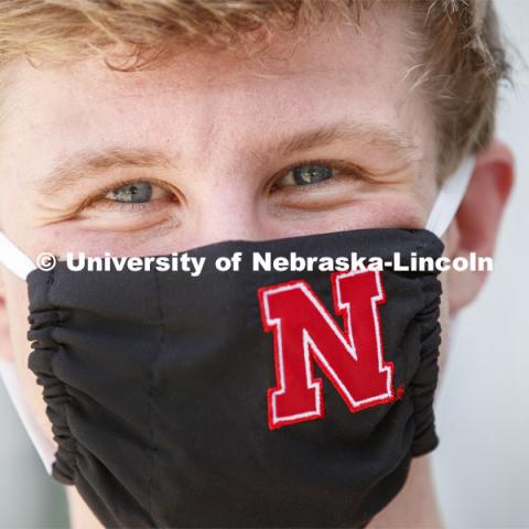 Joe Levey, senior in biology from Sturgis, SD wears a Husker mask. Photo shoot of students wearing masks and practicing social distancing in dining services in Willa Cather Dining Center. July 1, 2020. Photo by Craig Chandler / University Communication.