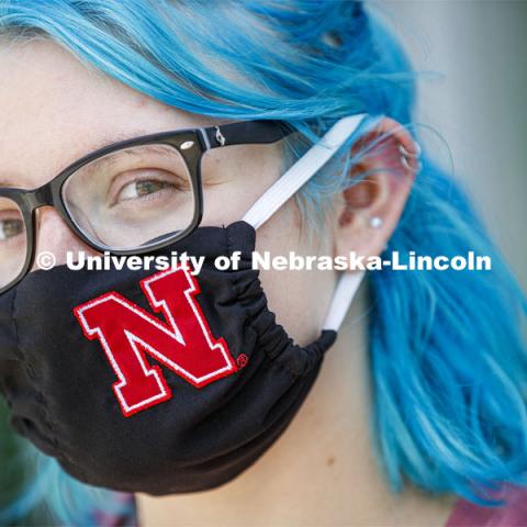 Atley Van Emmerik, a sophomore in dance from Glenvil, Nebraska wears a Husker mask. Photo shoot of students wearing masks and practicing social distancing in dining services in Willa Cather Dining Center. July 1, 2020. Photo by Craig Chandler / University Communication.