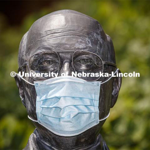 The statue of Clayton Yeutter, one of four Nebraskans who served as U.S. Secretaries of Agriculture, models a mask on the University of Nebraska-Lincoln's East Campus. The sculpture is one of many UNL campus sculptures wearing masks. Mask wearing statues on campus. July 6, 2020. Photo by Craig Chandler / University Communication.