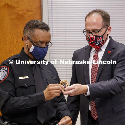 William Nunez, Vice Chancellor for Business and Finance, presents the police chief badge to Chief Hassan Ramzah. Ramzah had his badge presented to him today in a virtual ceremony from the police station. July 17, 2020. Photo by Craig Chandler / University Communication.
