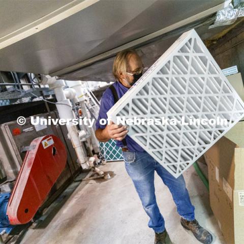 Lloyd Blessing, Zone Preventive Maintenance Associate, unpacks new air filters being installed in Westbrook Music Building to improve the air quality in campus buildings. To mitigate the risk of virus transfer within the buildings, the facilities team is increasing by nearly 50 percent the amount of fresh air being drawn into HVAC systems. They are also upgrading filters to more efficiently capture and reduce large and small particles in the air. July 27, 2020. Photo by Craig Chandler / University Communication.