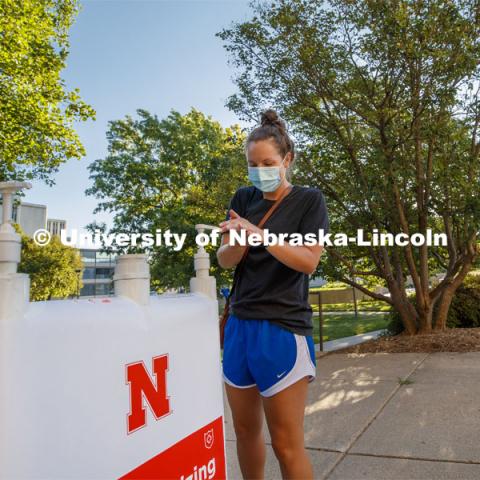 Maggie Ferguson, a May 2020 College of Business graduate, tries out a hand sanitizer station outside Westbrook Music Building. It is one of the more than 1,500 new hand sanitizer stations being distributed around the three UNL campuses. July 28, 2020. Photo by Craig Chandler / University Communication.