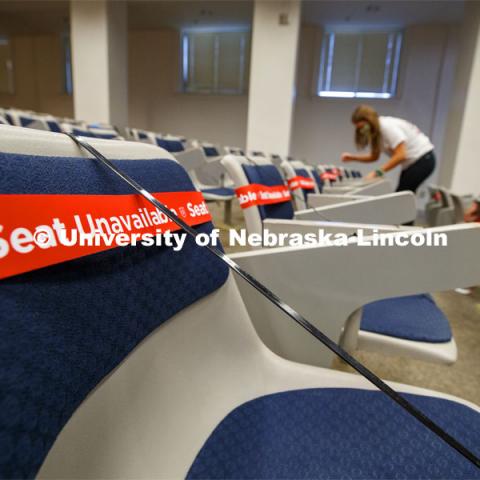 Marking classroom seats in Louise Pound Hall as part of preparing the campus for Forward to Fall. A crew is going room-to-room marking the where to sit and where the chairs/tables go. By Friday, they hope to have 483 classrooms and 8970 seats on all campuses marked and ready. August 3, 2020. Photo by Craig Chandler / University Communication.