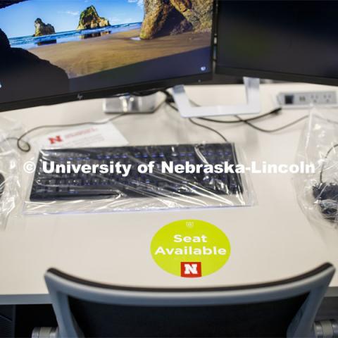 A seat-available sticker marking in the computer lab of the Johnny Carson Emerging Media Center. Crews mark classroom seats as part of preparing the campus for Forward to Fall. A crew is going room-to-room marking the where to sit and where the chairs/tables go. By Friday, they hope to have 483 classrooms and 8970 seats on all campuses marked and ready. August 3, 2020. Photo by Craig Chandler / University Communication.