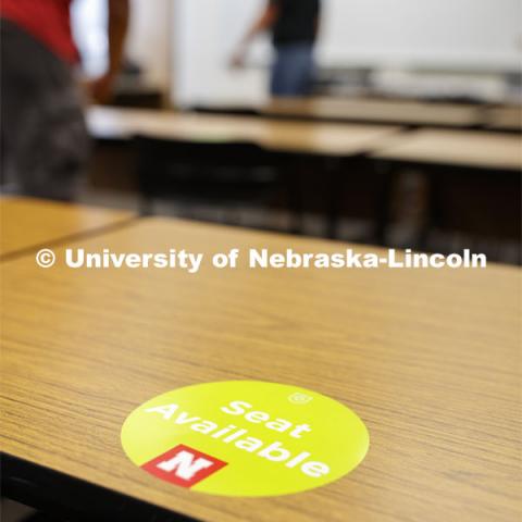 A seat-available sticker marking in the Temple building. Crews mark classroom seats as part of preparing the campus for Forward to Fall. A crew is going room-to-room marking the where to sit and where the chairs/tables go. By Friday, they hope to have 483 classrooms and 8970 seats on all campuses marked and ready. August 3, 2020. Photo by Craig Chandler / University Communication.