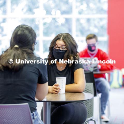 Photo shoot of students on city campus display mask wearing, social distancing. Students wearing masks while sitting together in the Nebraska Union. August 5, 2020. Photo by Craig Chandler / University Communication.