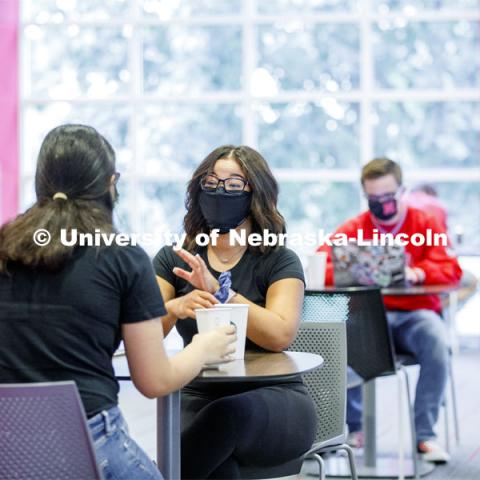 Photo shoot of students on city campus display mask wearing, social distancing. Students wearing masks while sitting together in the Nebraska Union. August 5, 2020. Photo by Craig Chandler / University Communication.