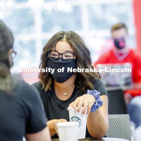 Photo shoot of students on city campus display mask wearing, social distancing. Students wearing masks while sitting together in the Nebraska Union. August 5, 2020. Photo by Craig Chandler / University Communication.