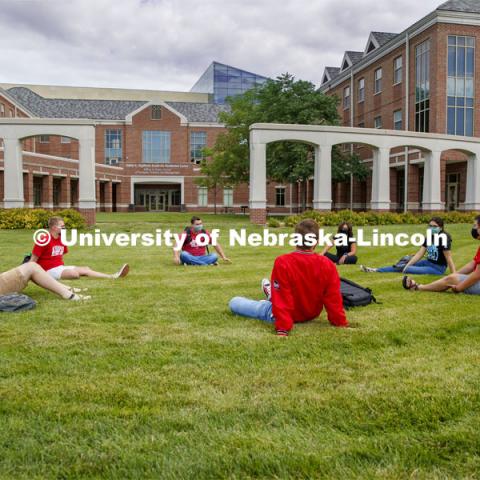 Photo shoot of students on city campus display mask wearing and social distancing. Students lounge on the grass outside Kauffman, all while maintaining a social distance. August 5, 2020. Photo by Craig Chandler / University Communication.