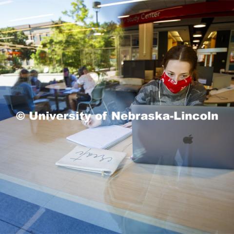 Anna Miles, a freshman from Benson, Arizona, studies from a table with a window view in the Adele Coryell Hall Learning Commons. First Day of classes on UNL campus. August 17, 2020. Photo by Craig Chandler / University Communication.