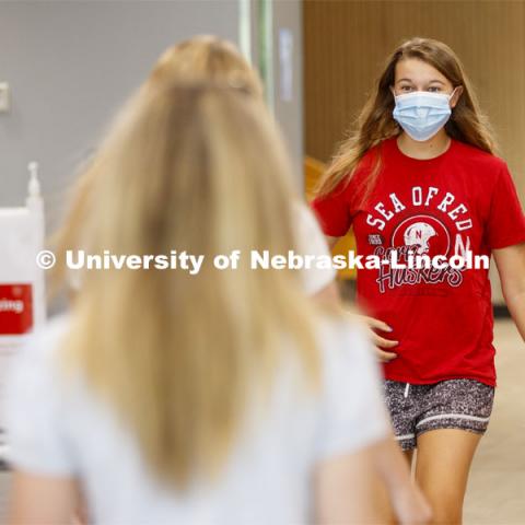 Allison Vana, a sophomore from Omaha, reacts as she sees friends on the first day of classes on UNL campus. August 17, 2020. Photo by Craig Chandler / University Communication.