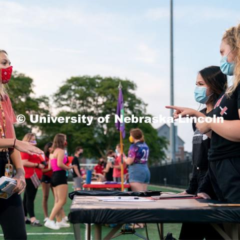 Members of the Nebraska Barbell Club (right) speak to a student during the HuskerMania Masker Singer event at Mabel Lee Fields. August 21, 2020. Photo by Jordan Opp for University Communication.