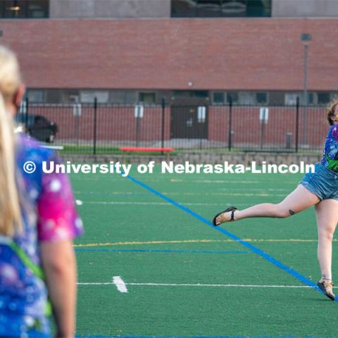 Michaela Ott (left) and Sierra Schuman (right) throw a frisbee back and forth before the start of the HuskerMania Masker Singer event at Mabel Lee Fields. August 21, 2020. Photo by Jordan Opp for University Communication.