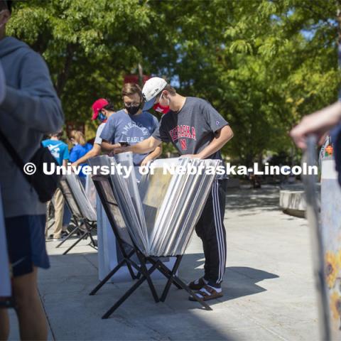 Jack Van Nieuwenhuyse and his Knoll Residence Hall roommate Easton Sckerl look over posters for sale in front of the Nebraska Union Monday. City Campus. August 31, 2020. Photo by Craig Chandler / University Communication.