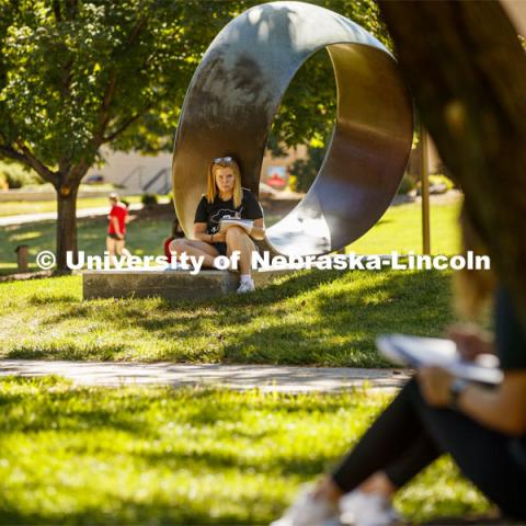 Ashley Beguin, freshman from Gordon, NE, sketches the scene in front of her. Chip Stanley's DSGN120 Design Drawing class works on figure drawing and proportions as they work outside of Architecture Hall Tuesday morning. On campus. September 2, 2020. Photo by Craig Chandler / University Communication.