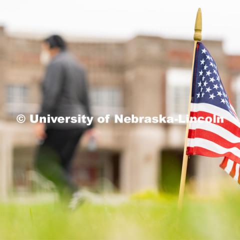 A student walks past an American flag placed in the Donald and Lorena Meier Commons on Thursday, September 10, 2020 in Lincoln, Nebraska. The flag is a part of a 9/11 memorial put together by the Association of Students of the University of Nebraska. 9/11 memorials. Photo by Jordan Opp for University Communication.