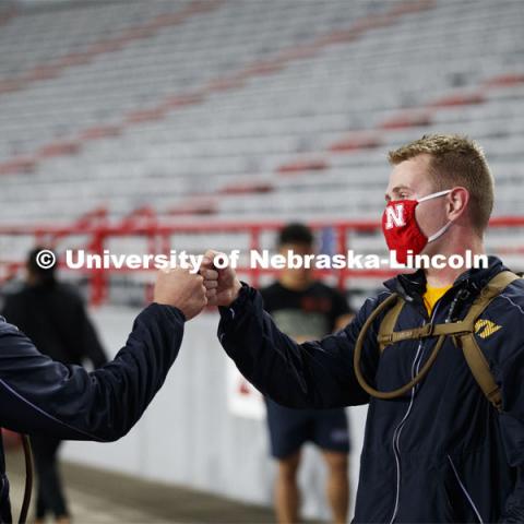Midshipmen Christian New, left, and Chris Haidvogel fist bump after completing the run. UNL ROTC cadets and Lincoln first responders run the steps of Memorial Stadium to honor those who died on September 11. Each cadet ran more than 2,000 steps. September 11, 2020. Photo by Craig Chandler / University Communication.