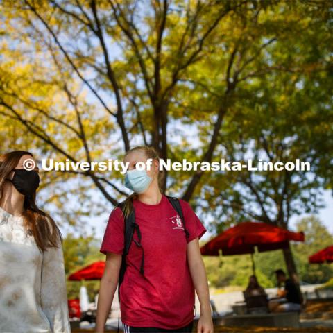 Brooklyn Guess, left, and Nicole Marienau walk through the plaza outside the Nebraska Union while wearing their masks on city campus. September 21, 2020. Photo by Craig Chandler / University Communication.