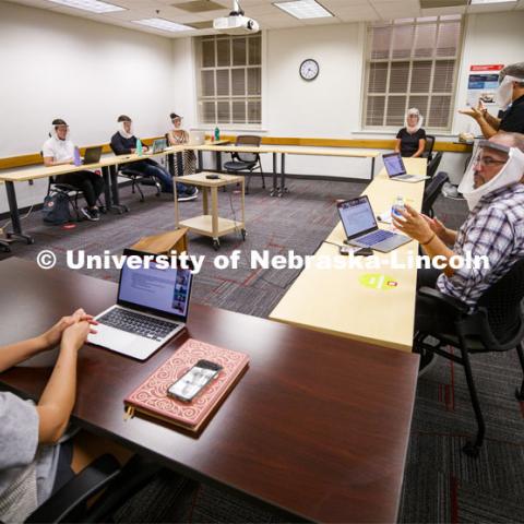Jordan Soliz, sitting at right, teaches his Social Identity and Intergroup Communication course. All those in the class wear special face shields to aid a hearing-impaired student. September 23, 2020. Photo by Craig Chandler / University Communication.