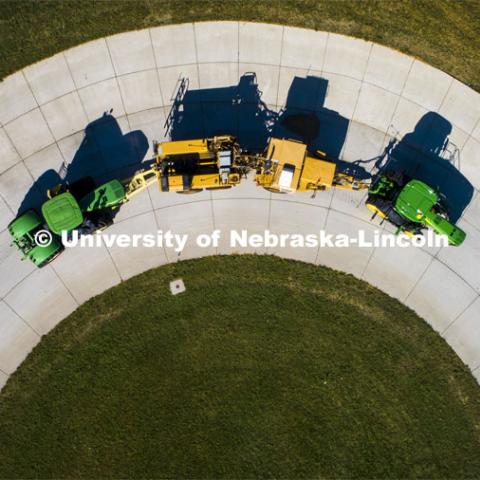 A tractor pulls the test car (yellow) and an additional tractor for weight as it rounds the test track on east campus. The University of Nebraska Tractor Test Laboratory (NTTL) is the officially designated tractor testing station for the United States. It has operated for more than 100 years. East Campus. September 28, 2020. Photo by Craig Chandler / University Communication.