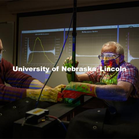 Bryan Leavitt (right), manager of research systems in the School of Natural Resources, and Ryan Moore, graduate assistant, adjust the tube holding the fiber optic lens in the portable scanner. CALMIT (Center for Advanced Land Management Information Technologies) built a mobile hyperspectral scanning system to teach students scanning since the basement darkroom in Hardin Hall does not allow for social distancing. October 1, 2020. Photo by Craig Chandler / University Communication.