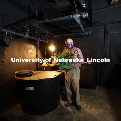 Bryan Leavitt, Manager Research Systems Survey Division - School of Natural Resources, holds a plant in the basement darkroom. The room can't be used this fall as it does not allow for social distancing. CALMET (Center for Advanced Land Management Information Technologies) built a mobile hyperspectral scanning system to teach students scanning since the basement darkroom in Hardin Hall does not allow for social distancing. October 1, 2020. Photo by Craig Chandler / University Communication.