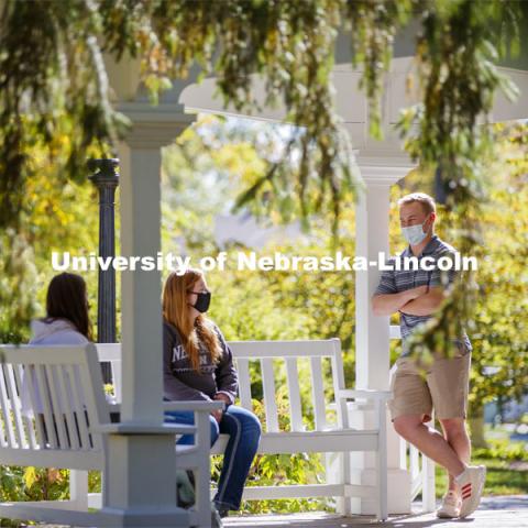 Students enjoy the afternoon on Perin Porch on east campus. East Campus photo shoot. October 13, 2020.  Photo by Craig Chandler / University Communication