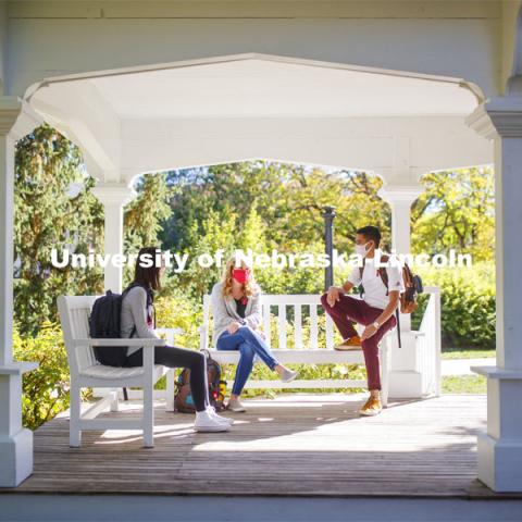 Tori Huffman, Sydney Brewer, and Sushant Timalsina enjoy the afternoon on Perin Porch on east campus. East Campus photo shoot. October 13, 2020.  Photo by Craig Chandler / University Communication