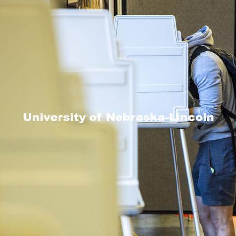 Hunter Parker, from Los Angeles, ponders the ballot as he votes in his first presidential election. Voting in the Nebraska Union for the 2020 Presidential Election. November 3, 2020. Photo by Craig Chandler / University Communication.