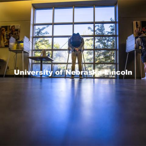 Hunter Parker, from Los Angeles, ponders the ballot as he votes in his first presidential election. Voting in the Nebraska Union for the 2020 Presidential Election. November 3, 2020. Photo by Craig Chandler / University Communication.