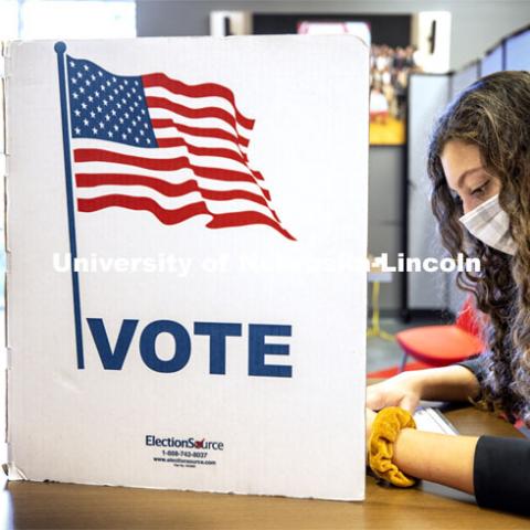 Grace Carey, a freshman from Bellevue, Nebraska, votes in her first election. Voting in the Nebraska Union for the 2020 Presidential Election. November 3, 2020. Photo by Craig Chandler / University Communication.