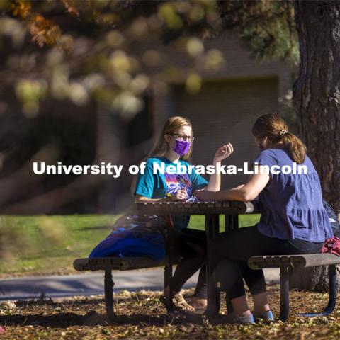 Madyson Hamling (dark blue top) and Emma Arthur study outside the Barkley Memorial Center on a warm November day. The two are speech pathology students. East Campus. November 6, 2020. Photo by Craig Chandler / University Communication.