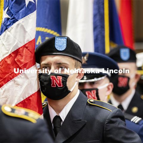 Joseph Carlin carries the US flag as part of the ROTC Color Guard. Volunteers read the names of nearly 5,000 Nebraskans who have perished in wars since World War I. The University of Nebraska–Lincoln joined campuses nationwide in a moment of silence at 1 p.m. on Veterans Day, to honor American men and women who died in service to their country. The moment of silence is part of National Roll Call 2020, a Veterans Day remembrance. This year, ROTC also did a POW/MIA ceremony before the National Roll Call. November 11, 2020. Photo by Craig Chandler / University Communication.