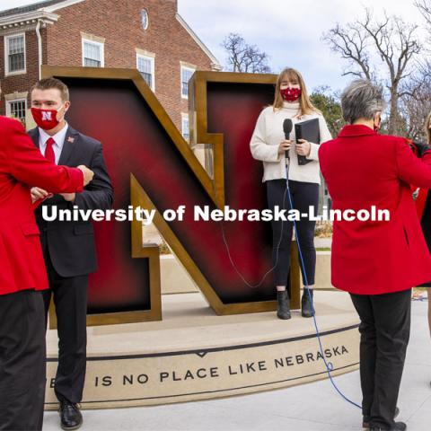 Chancellor Ronnie Green presents a medallion to Cooper Grabenstein of Smithfield, Nebraska, while Jane Green presents a medallion to Lauren Kubat of Omaha. Grabenstein and Kubat were crowned Homecoming Royalty in a delayed ceremony after the Wisconsin homecoming game was canceled. They were crowded at the Nebraska Alumni Center in front of the The Value of N sculpture.  Student Regent and Student Body President Roni Miller MC’d the crowning. Nebraska v. Penn State football. November 14, 2020. Photo by Craig Chandler / University Communication.