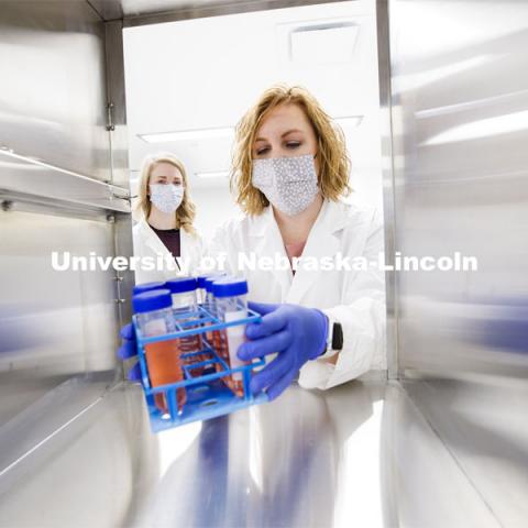 Kristin Beede, research manager with the Department of Food Science and Technology, passes bacterial cultures from the laboratory to the procedure room, where graduate student Ashley Toney awaits them. Nebraska Food for Health Center. November 19, 2020. Photo by Craig Chandler / University Communication.
