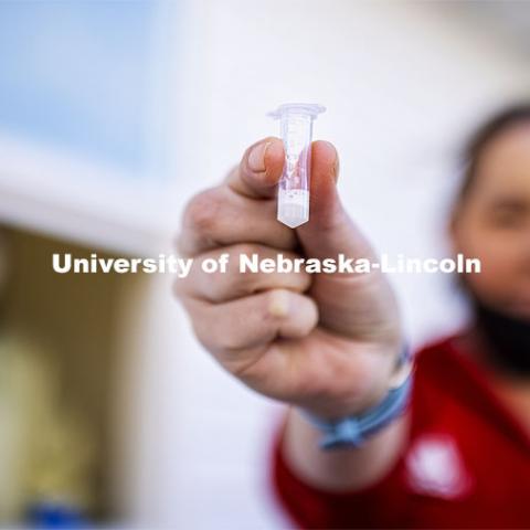 Jessica Calvi, a research assistant professor with the Nebraska Athletic Performance Lab, demonstrates the new saliva-based COVID test as Stephanie Padilla, R.N. watches. In the Spring, students, faculty and staff on campus will be using the test. December 2, 2020. Photo by Craig Chandler / University Communication.