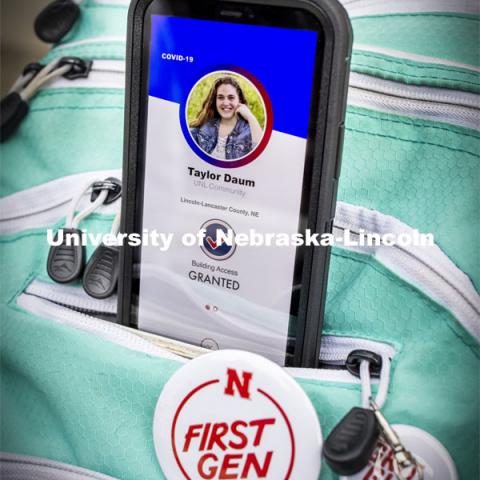 Taylor Daum shows the Safer Community app to be used as part of COVID testing on campus this spring. Phone screen is simulated and may change slightly in the final rollout. January 8, 2021. Photo by Craig Chandler / University Communication.