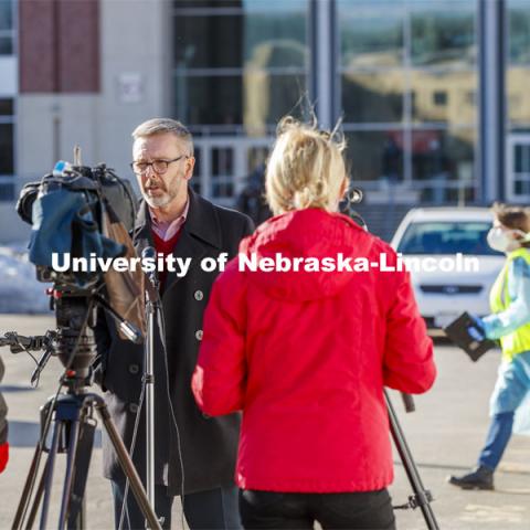 Chancellor Ronnie Green talks with media and takes his COVID-19 saliva test Tuesday afternoon at the East Stadium loop site.  January 19, 2021. Photo by Craig Chandler / University Communication