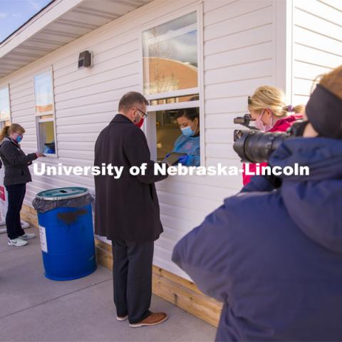 Chancellor Ronnie Green checks his personal information before receiving his COVID-19 saliva test kit Tuesday afternoon at the East Stadium loop site.  January 19, 2021. Photo by Craig Chandler / University Communication