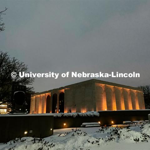 Sheldon is lit up on a snowy night on City Campus. Snow in January on City Campus. January 27, 2021. Photo by Katie Black / University Communication.