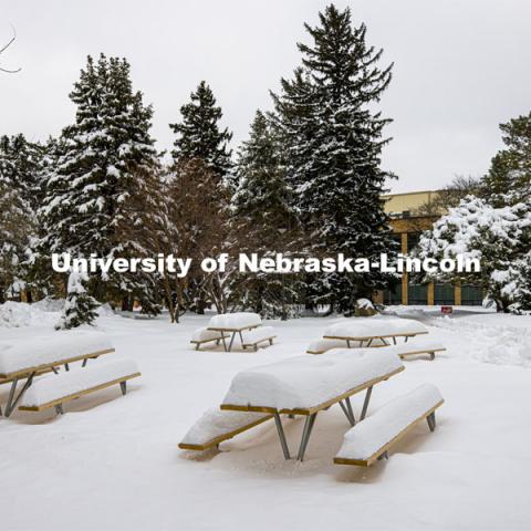 The picnic tables outside of the Nebraska East Union on East Campus are covered in more than 14” of snow from the snowstorm on Monday. January 28, 2021. Photo by Craig Chandler / University Communication.
