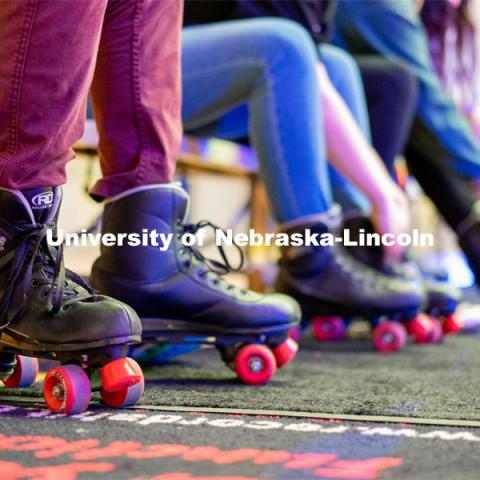 Students put on their pair of rollerblades before skating during the Club 80 Roller Skating Event in the Nebraska Union Ballroom on Friday, February 19, 2021, in Lincoln, Nebraska. Photo by Jordan Opp for University Communication.