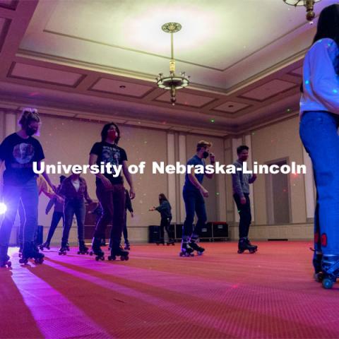 Students skate in a circle during the Club 80 Roller Skating Event in the Nebraska Union Ballroom on Friday, February 19, 2021, in Lincoln, Nebraska. Photo by Jordan Opp for University Communication.