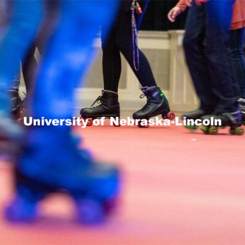 Students skate in a circle during the Club 80 Roller Skating Event in the Nebraska Union Ballroom on Friday, February 19, 2021, in Lincoln, Nebraska. Photo by Jordan Opp for University Communication.