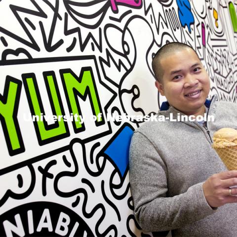 Duy Nguyen holds a cone of his favorite flavor, Butterscotch Frost. Duy Nguyen is the manager of the Dairy Store. February 26, 2021. Photo by Craig Chandler / University Communication.