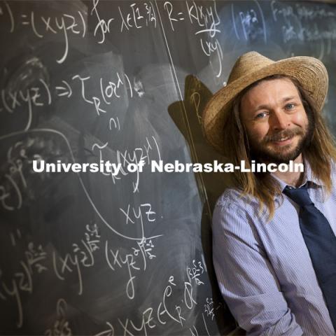 Jack Jeffries, assistant professor of mathematics, is a NSF CAREER winner. On the blackboard are some computations of Bernstein-Sato roots. His research is in Commutative Algebra including invariant theory, positive characteristic techniques, differential operators, local cohomology, generalized multiplicities, symbolic powers, and applications to neuroscience. March 31, 2021. Photo by Craig Chandler / University Communication
