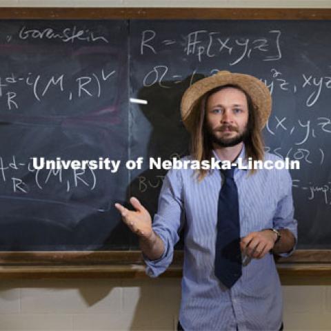 Jack Jeffries, assistant professor of mathematics, is a NSF CAREER winner. On the blackboard are some computations of Bernstein-Sato roots. His research is in Commutative Algebra including invariant theory, positive characteristic techniques, differential operators, local cohomology, generalized multiplicities, symbolic powers, and applications to neuroscience. March 31, 2021. Photo by Craig Chandler / University Communication