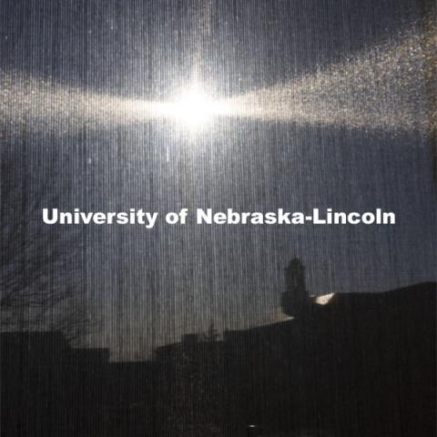 Love Library is seen silhouetted through the window shade in a Hamilton Hall chemistry lab.  April 1, 2021. Photo by Craig Chandler / University Communication.